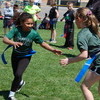 GMR second graders Aliyah Kern and Kilah Sather attempt to take each other’s flags as the final two GMR second grade students remaining in the girls’ flag tag event, as part of Gator Day on May 19. (photo by Ryan Bergeron)