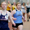 Katelyn Waage runs with a baton in her hand during a relay event at the University of North Dakota Fritz Pollard Athletic Center in Grand Forks for an East Grand Forks-hosted indoor track and field meet on April 19. (photo by Bruce Brierley)