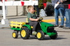 Aiden Bauman drives this miniature tractor through the Badger Fall Fest Parade on September 16, as part of the Lil Chomper’s Child Care parade entry. (photo by Ryan Bergeron)
