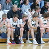 Gator Boys Basketball players sit on the bench, some visibly showing their emotions, in the closing minutes of the team’s 71-33 season-ending loss to the Kittson County Central Bearcats in the pig-tail round of the Section 8A Boys Basketball Tournament on March 4 in Lancaster. (photo by Ryan Bergeron)
