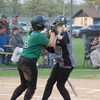 Elizabeth Gust (left) celebrates with fellow Gator senior teammate Kinsley Hanson after Gust escaped a rundown between second and third and eventually scored on the play in the third inning of the Gator Softball team’s 13-3 five-inning playoff-opening home victory over the Mahnomen-Waubun Thunderbirds on May 23. For the game, the Gators finished with seven stolen bases and 11 hits. (photo by Ryan Bergeron)