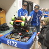 Gator Robotics team members Quinn Pittman (left) and Vincent Stenberg (middle) show Chandler Wahl (right) how the team’s robot works. The Gator Robotics team hosted a fundraiser on March 17 from 11:00 am to 1:30 pm at the Greenbush American Legion, an event featuring a free-will turkey meal, raffle and silent auction items, tattoos, and team merchandise for purchase. The team next competes at the Minnesota Granite City Regional in St. Cloud, April 4-7. (photo by Ryan Bergeron)