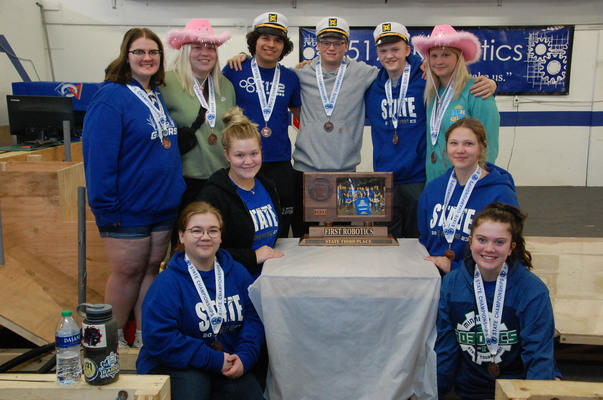 The GMR Robotics team sports it third place medals and poses with its third place state tournament team plaque during its welcome home event at the STEM Center in Greenbush on May 7. The team also earned a regional championship and trip to the World Championship this season. Pictured are (L-R): Back: Carissa Prevost, Berlyn Burkel, Sawyer Strand, Vincent Stenberg, Quinn Pittman, and Brooklyn Wahl; Front: Jozie Stohs, Bella Burkel, Jalyssa Gust, and Brylie Kjersten. (photo by Ryan Bergeron)