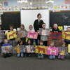 Badger kindergarten students showcase the art pieces they created during a lesson with Badger School artist in residence, Alyssa Aune. They displayed two art pieces: the Swedish Dala Horse and dogs painted, highlighting movement throughout the artwork. Pictured are (L-R): Row One: Jack Berger, Ghazi Jean, Brynlee Moore, Ayven Hietala, Taylor Randall, Crystal Mekovich, and Lucas Erickson; Row Two: Evan Haugen, Julius Jenson, Charlotte Daignault, Ivy Seydel, James Evans, Deklyn Madoll, and Colt Langaas; Row Three: Mrs. Aune. (submitted photo)